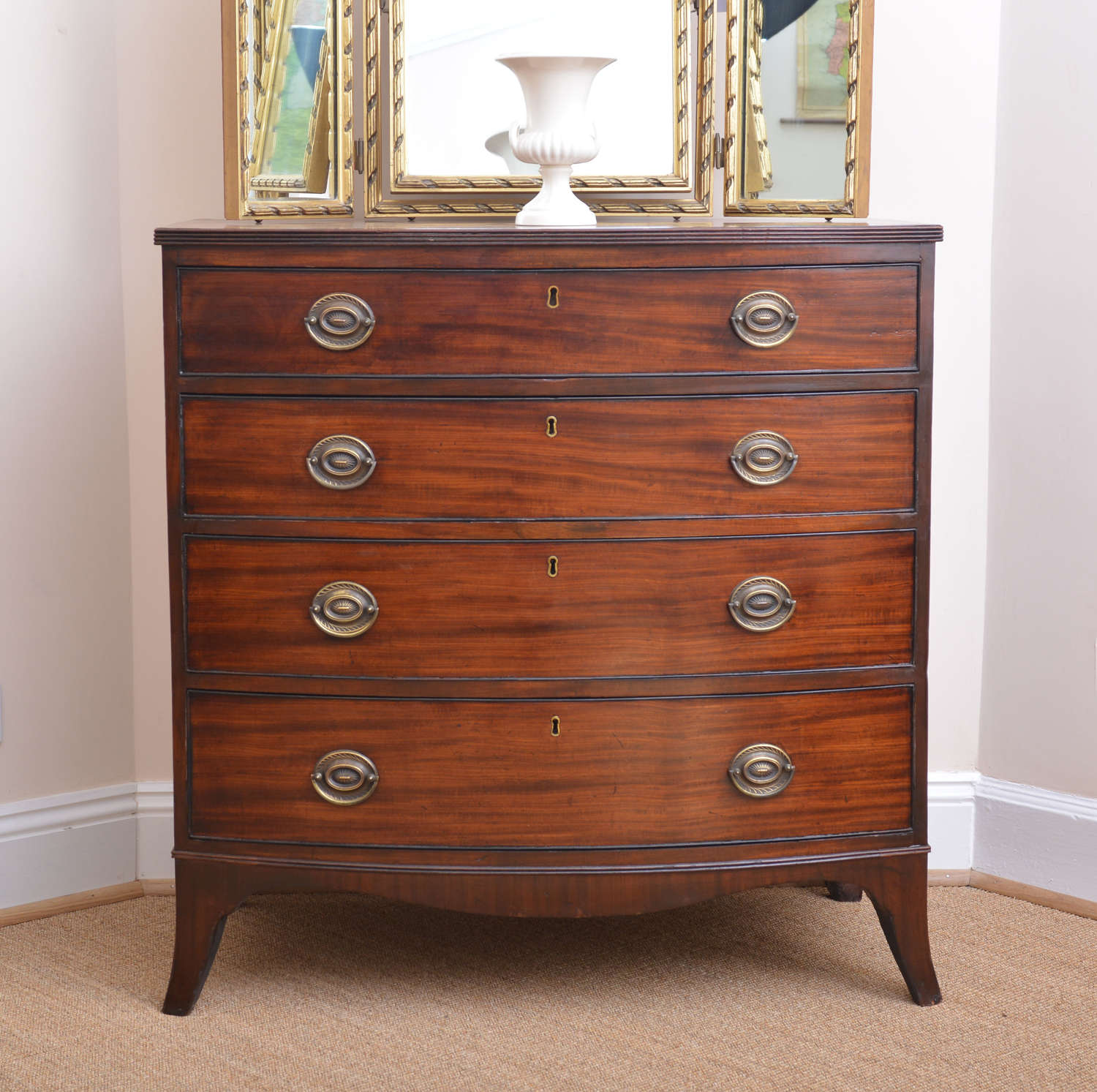 Small bow-fronted chest of drawers, circa 1830