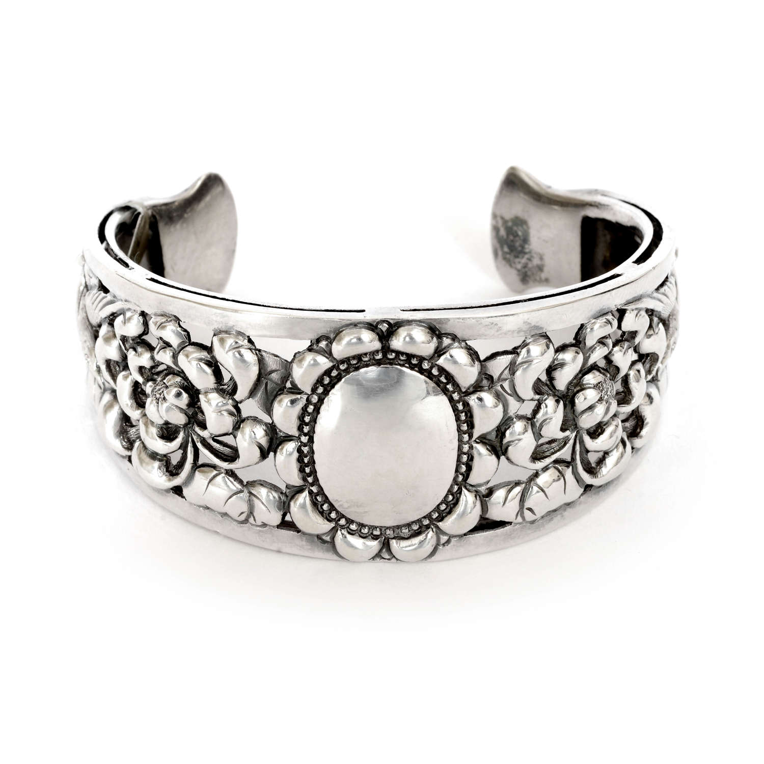 A Victorian silver cuff with birds and flowers.