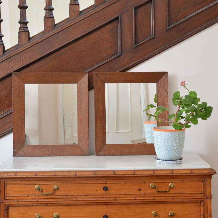 A pair of oak framed mirrors
